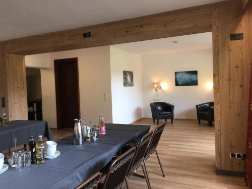 a dining room with a blue table and chairs at Quartier Severin in Berwang