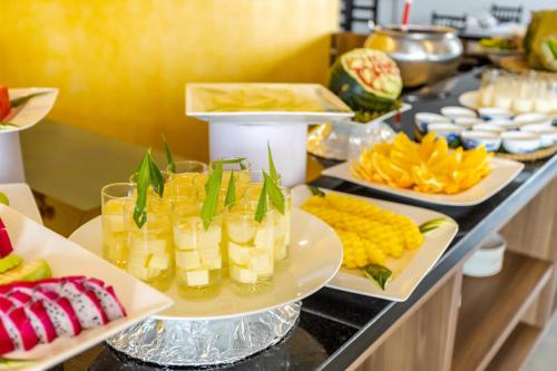 a buffet with several plates of food on a table at White Lotus Hue Hotel in Hue