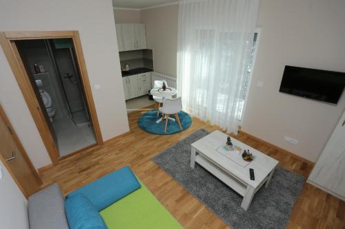 a living room with a couch and a table at Mipet apartmani in Zlatibor