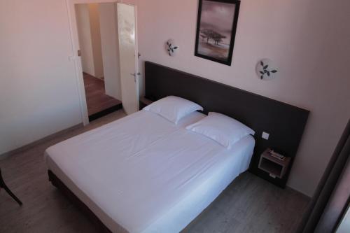 Ένα ή περισσότερα κρεβάτια σε δωμάτιο στο Hôtel le Relais de Vendée