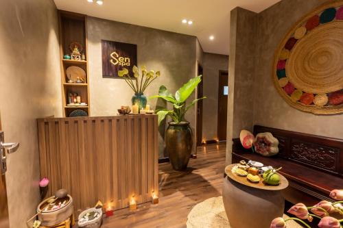 a living room with a table with food on it at White Lotus Hue Hotel in Hue