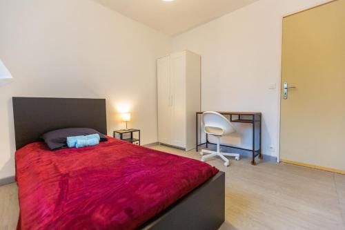 een slaapkamer met een groot rood bed en een stoel bij Superbe T4 renove spacieux avec stationnement libre et gratuit in Marseille