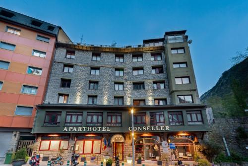 a hotel in the mountains with a building at Apartaments Turístics Conseller in Andorra la Vella
