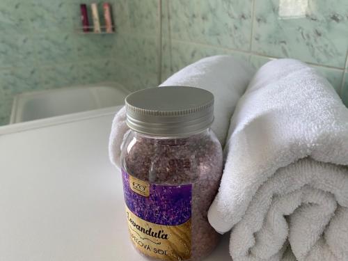 a mason jar sitting on a bathroom counter next to towels at Apartmán Ivka in Brezno