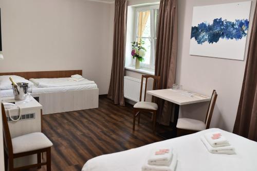 A bed or beds in a room at Wellness Hotel Bozeňov