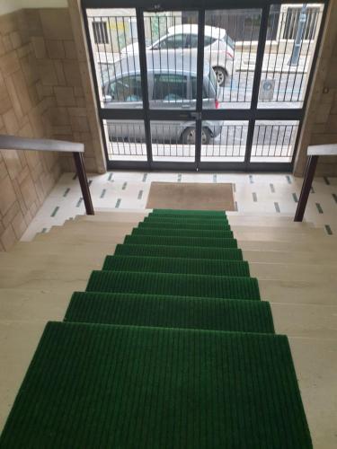 an empty room with green stairs in a building at Alba central City in Palermo