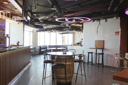 a room with tables and stools in a restaurant at Al Diar Dana Hotel in Abu Dhabi