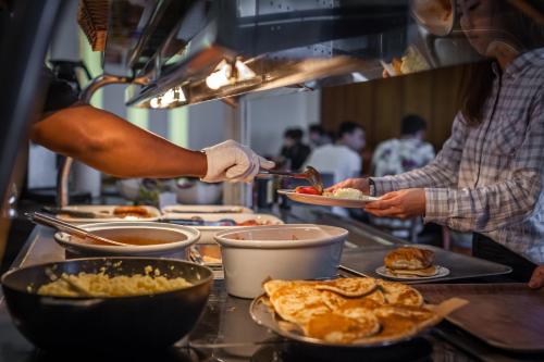 two people preparing food in a restaurant kitchen at LSE Carr-Saunders Hall in London