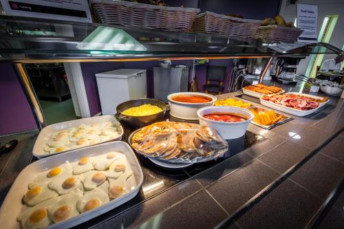 a buffet of food is displayed in a restaurant at LSE Carr-Saunders Hall in London