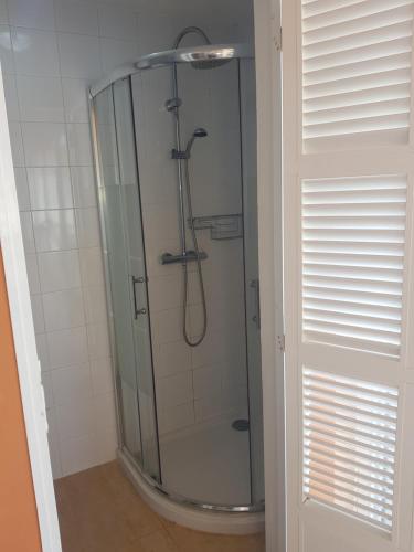 a shower with a glass door in a bathroom at Casa Calma in Son Serra de Marina