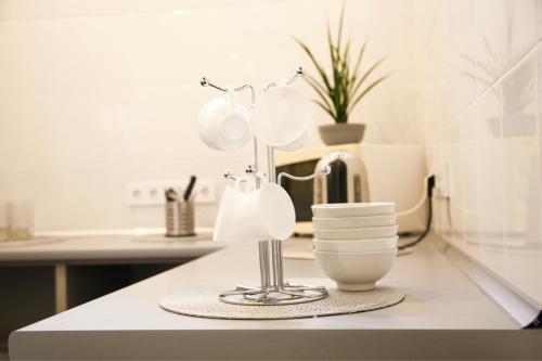 a kitchen counter with a lamp and dishes on it at Atmosphere Capsule Hostel in Tyumen