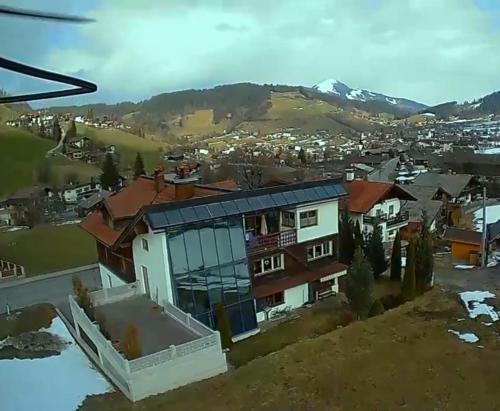 arial view of a house with mountains in the background at Ferienwohnung Neuheim in Niederau