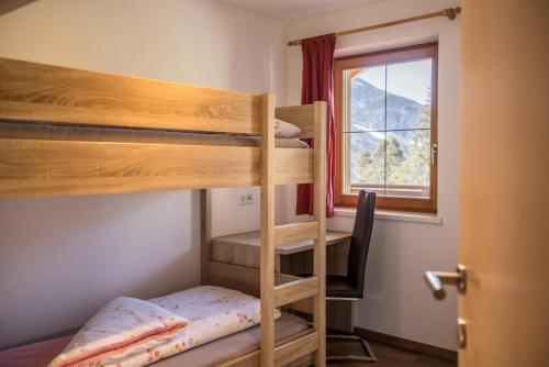 a room with two bunk beds and a window at Golserhof Sonne in Cadipietra