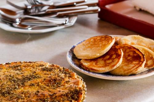 a plate of food with pancakes on a table at Pousada Araujo Bazilio in Tiradentes