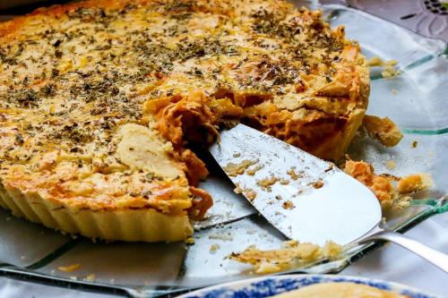 a pie sitting on a glass plate with a knife at Pousada Araujo Bazilio in Tiradentes