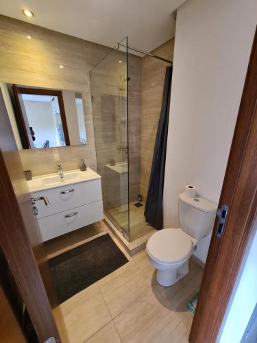 a bathroom with a toilet and a glass shower at Préstigia Agate 258 in Marrakesh