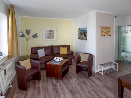 a living room with a couch and chairs and a table at Villa Binz - Apt. 02 in Binz