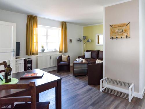 a living room with a couch and a table at Villa Binz - Apt. 02 in Binz