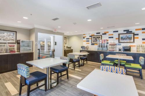 a fast food restaurant with tables and chairs at Sleep Inn & Suites Columbus near Fort Benning in Columbus