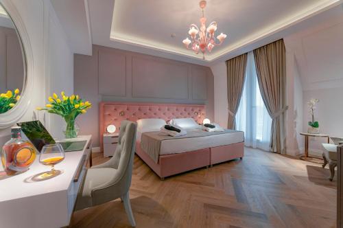 a bedroom with a bed and a table with a wine glass at Hotel Premiere Abano in Abano Terme