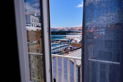 a view of a city from a window at Mid-Atlantic Boutique Hostel in Angra do Heroísmo