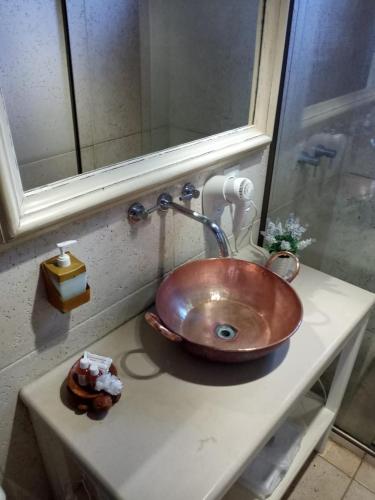 a bathroom with a copper sink on a counter at Pousada Araujo Bazilio in Tiradentes