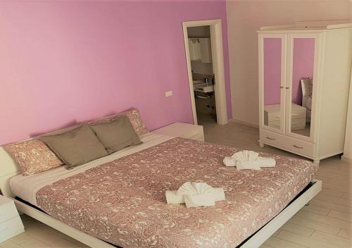 a bedroom with a large bed with two towels on it at Have A Nice Holiday - Luxury Rooms in Rome