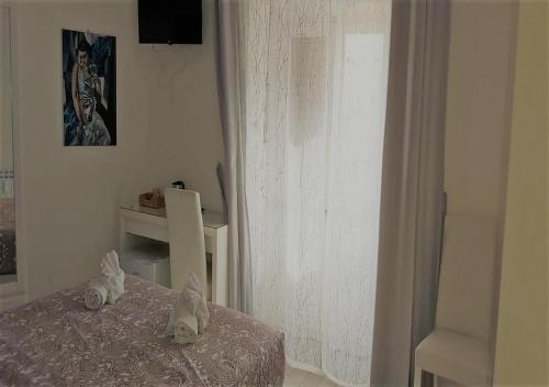 a white room with a bed and a window at Have A Nice Holiday - Luxury Rooms in Rome