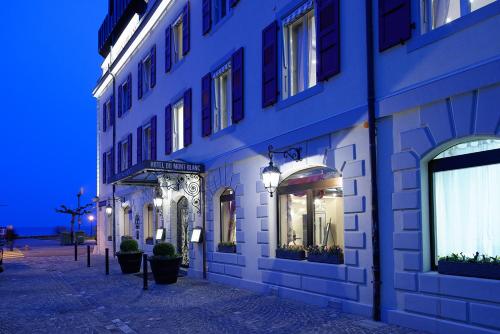 a row of buildings on a street at night at Romantik Hotel Mont Blanc au Lac in Morges