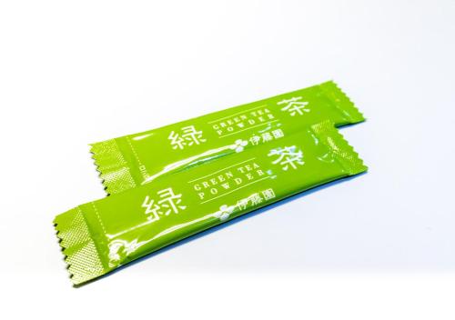 a packet of green packets with asian writing on them at APA Hotel Keisei Narita Ekimae in Narita