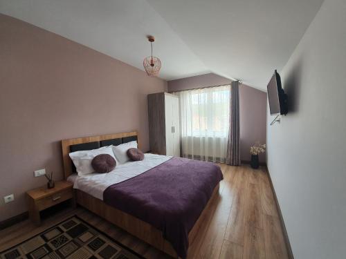 a bedroom with a bed and a television in it at Edith's House in Turda