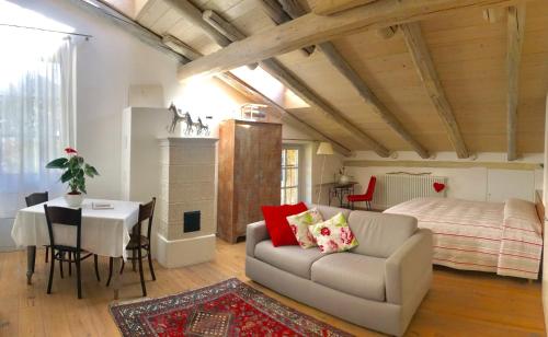 a living room with a couch and a table and a bed at Casa del Pittore in Rovereto