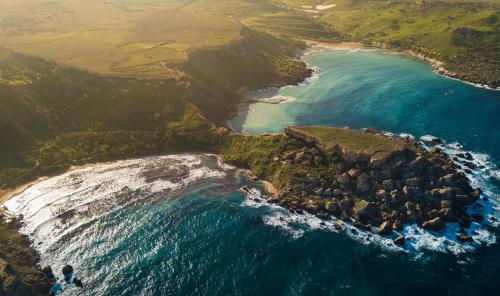 an aerial view of the ocean and a rocky coastline at Hyatt Regency Malta in St Julian's