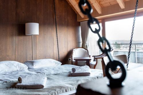a bedroom with a swing bed with two towels at Vinica Castle Boutique & Spa Hotel in Vinica