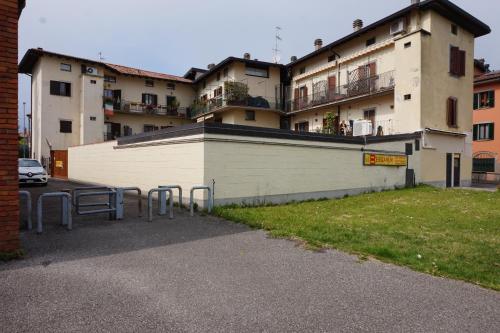a parking lot with tables in front of a building at Bergamum F.L. in Bergamo