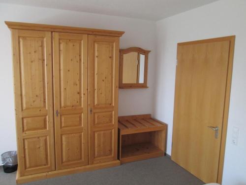 a room with a wooden cabinet and a closet at Gasthaus Kreuz in Ühlingen-Birkendorf