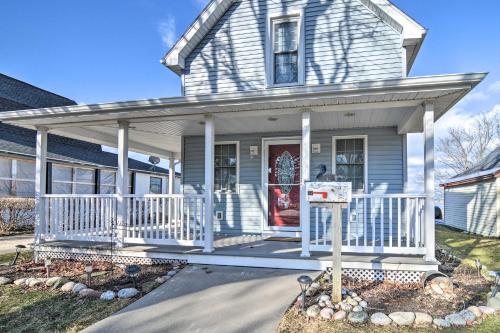 a house with a porch with a white railing at Downtown Boyne City Home, Walk to Lake Charlevoix! in Boyne City
