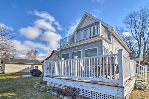 a house with a porch with a white railing at Downtown Boyne City Home, Walk to Lake Charlevoix! in Boyne City