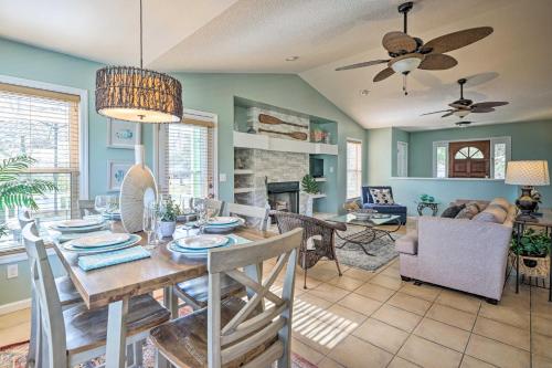 a dining room and living room with a table and chairs at Coastal Hideaway about half Mi to Beach and Boardwalk! in Carolina Beach