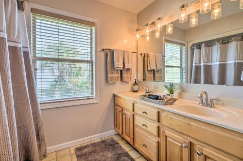 a bathroom with a sink and a large mirror at Coastal Hideaway about half Mi to Beach and Boardwalk! in Carolina Beach