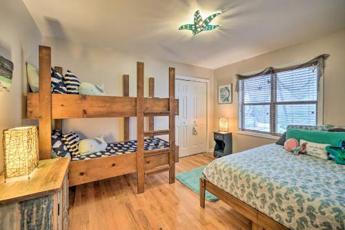 a bedroom with a bunk bed and a bed sqor at Coastal Hideaway about half Mi to Beach and Boardwalk! in Carolina Beach