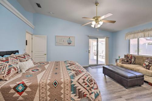 a bedroom with a bed and a ceiling fan at Bright Lake Havasu City Abode with Private Pool in Lake Havasu City