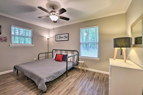 a bedroom with a bed and a ceiling fan at Serene Live Oak Home with Fire Pit by River and SOSMP! in Live Oak