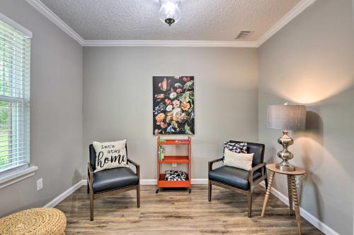 a living room with two chairs and a table at Serene Live Oak Home with Fire Pit by River and SOSMP! in Live Oak