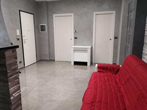 a living room with a red couch and a table at CAV Black Pearl by People in Turin