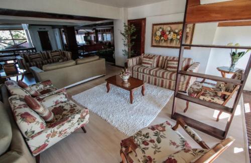 a living room with a couch and a table at Apto ao lado da Rua Torta in Gramado