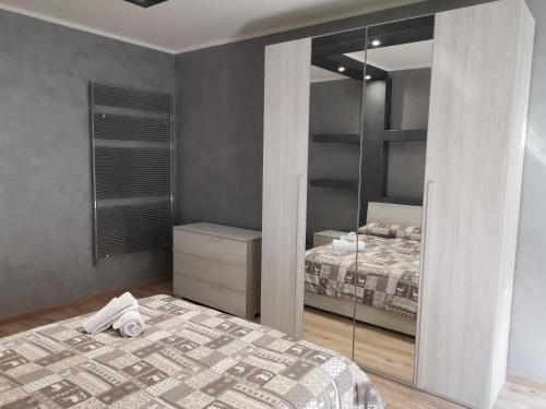 a bedroom with a bed and a large mirror at CAV Black Pearl by People in Turin