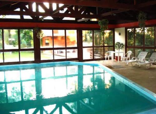 a large swimming pool in a house at Apto ao lado da Rua Torta in Gramado