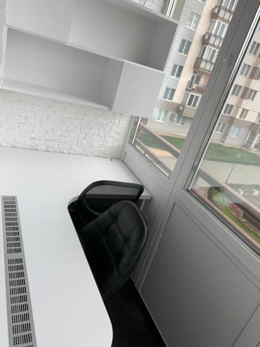 a black chair in a room with a window at VIP Apartments 16 in Odesa