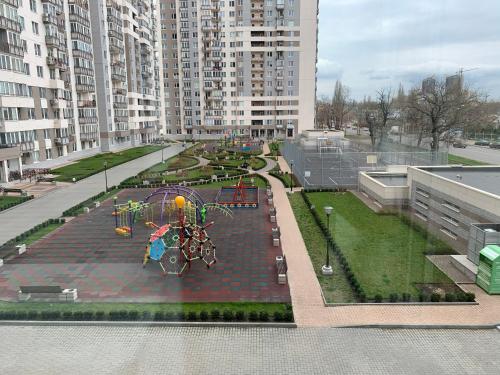 a playground in the middle of a city with tall buildings at VIP Apartments 16 in Odesa